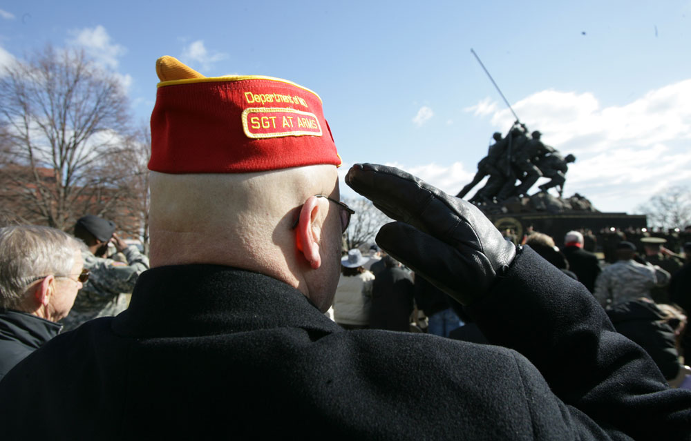 Veterans and friends of Marines honored the flag as it slowly ascended the flagpole of the Memorial.